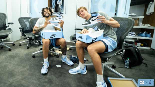 North Carolina basketball players open Air Jordan shoe boxes.